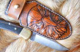 The sheath is handmade from carved leather Condor